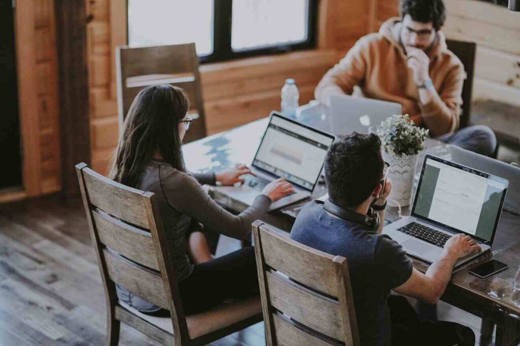 People sitting around computer